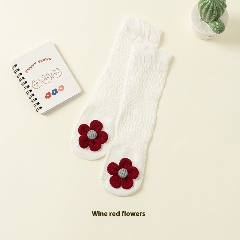 white baby socks with small flower detail